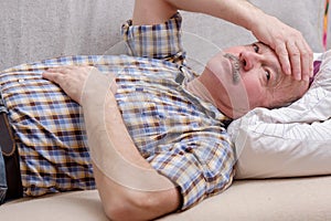 Portrait of happy senior man smiling at home