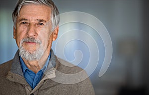 Portrait of happy senior man smiling at home