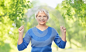 Portrait of happy senior woman celebrating success