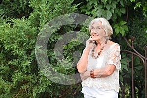 Portrait of happy senior woman posing at forest