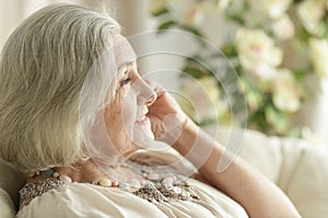 Portrait of happy senior woman resting at home