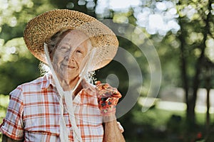 Portrait of a happy senior woman with a straw hat