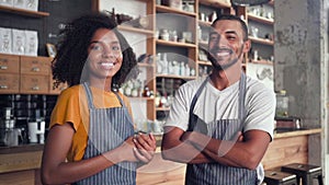 Portrait of happy small business partners in cafe