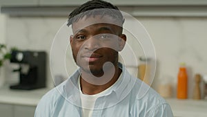 Portrait happy smiling African American friendly renter homeowner man at home kitchen modern morning breakfast food