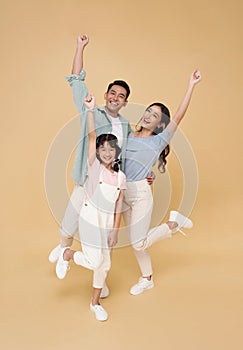 Portrait happy smiling Asian family celebrate winner together isolated on color background