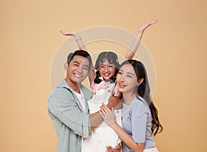 Portrait happy smiling Asian family hugging and love together isolated on color background