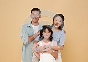 Portrait happy smiling Asian family hugging and love together isolated on color background