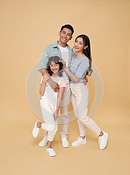 Portrait happy smiling Asian family hugging and love together isolated on color background