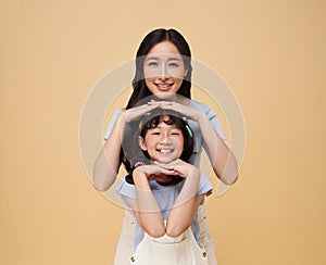 Portrait happy smiling Asian family hugging and love together isolated on color background. happy mother's day