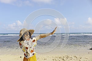 Portrait of happy smiling Asian woman on the beach wear hat