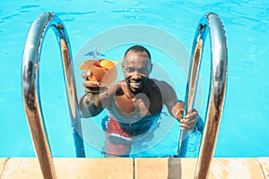 The portrait of happy smiling beautiful man at the pool