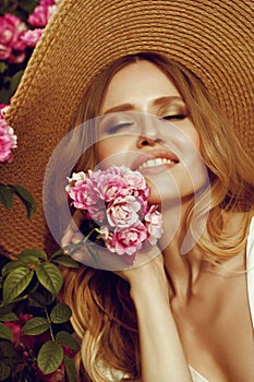 Portrait Happy smiling Beautiful young woman posing near flowers in a garden.