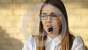 Portrait of happy smiling blonde female customer support phone operator