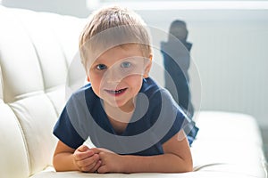 Portrait of happy smiling boy. Attractive kid at home.