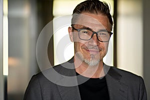 Portrait of happy smiling businessman at office