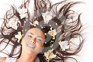 Portrait of Happy Smiling Caucasian Brunette Woman Laying on Floor With Hair Outspread