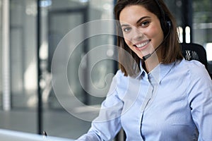 Portrait of happy smiling cheerful support phone operator in headset at office