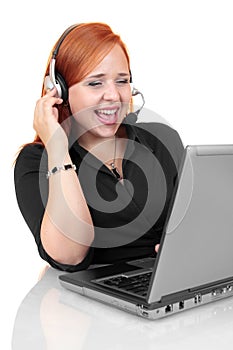 Portrait of happy smiling cheerful young support phone operator in headset with laptop