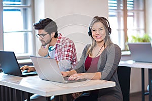 Portrait of happy smiling customer support phone operator