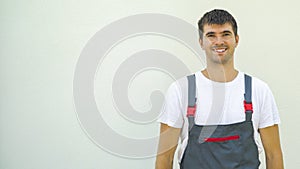 Portrait happy smiling engineer isolated on light background looking at camera with free copy space