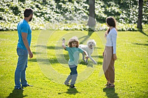 Portrait of a happy smiling family with dog relaxing in park.