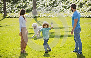 Portrait of a happy smiling family with dog relaxing in park.