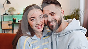 Portrait of happy smiling family marriage couple man woman looking at camera, hugging, embracing