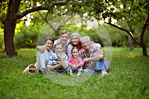 Portrait of happy smiling family relaxing in park