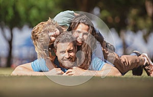 Portrait of a happy smiling family relaxing in park.