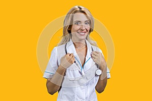 Portrait of happy smiling female blonde doctor with stethoscope.