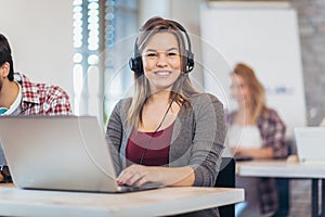 Portrait of happy smiling female customer support phone operator