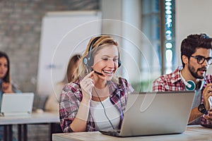 Portrait of happy smiling female customer support phone operator