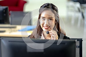 Portrait of happy smiling female customer support phone operator at workplace. Professional operator concept