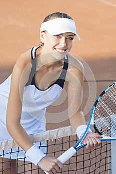 Portrait of Happy Smiling Female Tennis Player at Court Standing
