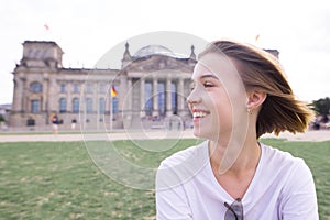 Portrait of a happy smiling girl in Berlin, Germany. Smiling student on the background of European architecture