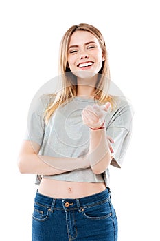 Portrait of a happy smiling girl pointing finger at camera