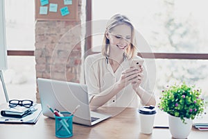 Portrait of happy smiling glad secretary who typing sms on her s