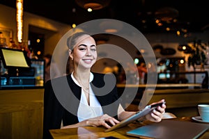 Portrait of a happy smiling gorgeous woman owner successful restaurant holding touch pad