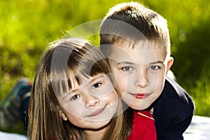 Portrait of happy smiling little children boy and girl on sunny