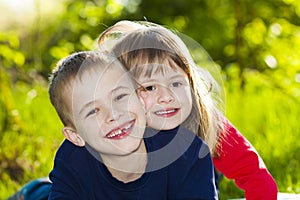 Portrait of happy smiling little children boy and girl on sunny