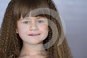 Portrait of happy smiling little girl with beautiful thick hair