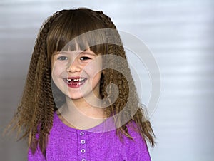 Portrait of happy smiling little girl with beautiful thick hair