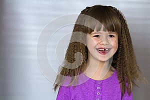 Portrait of happy smiling little girl with beautiful thick hair