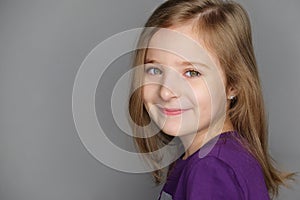 Close-up portrait of happy smiling little girl; studio shot
