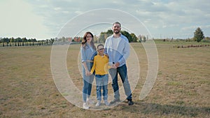 Portrait happy smiling lovely Caucasian parents family dad mom father mother little boy child kid looking at camera