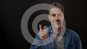 Portrait of happy smiling mid adult man showing thumb up