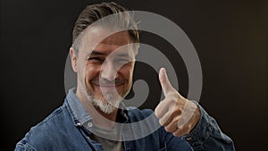 Portrait of happy smiling mid adult man showing thumb up