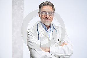 Portrait of happy smiling mid adult medical doctor on white