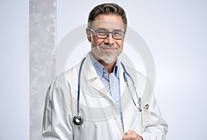 Portrait of happy smiling mid adult medical doctor on white