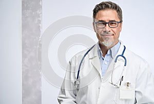 Portrait of happy smiling mid adult medical doctor on white